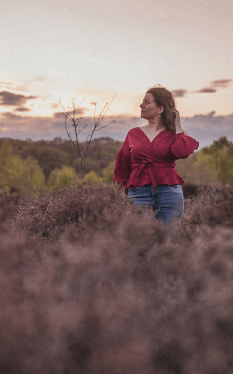 Moira Fuller, Business Strategist in the UK, standing outdoors in nature at sunset